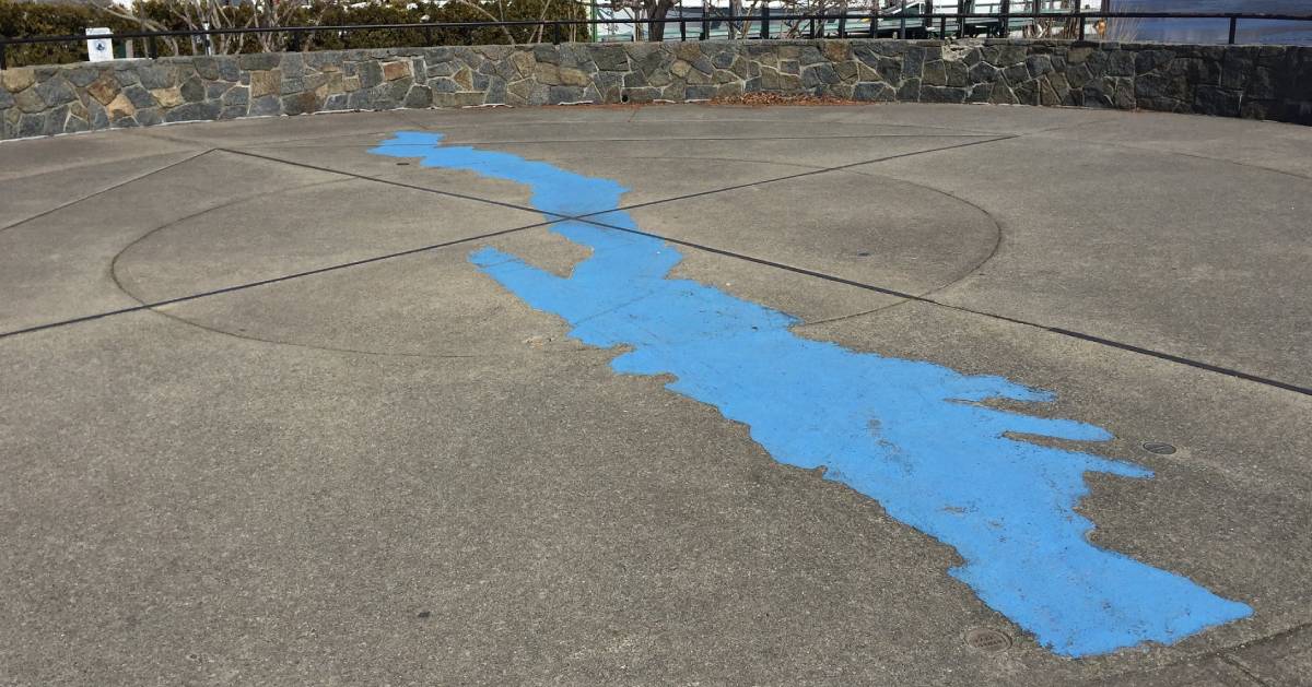 blue image of Lake George on a circular cement space