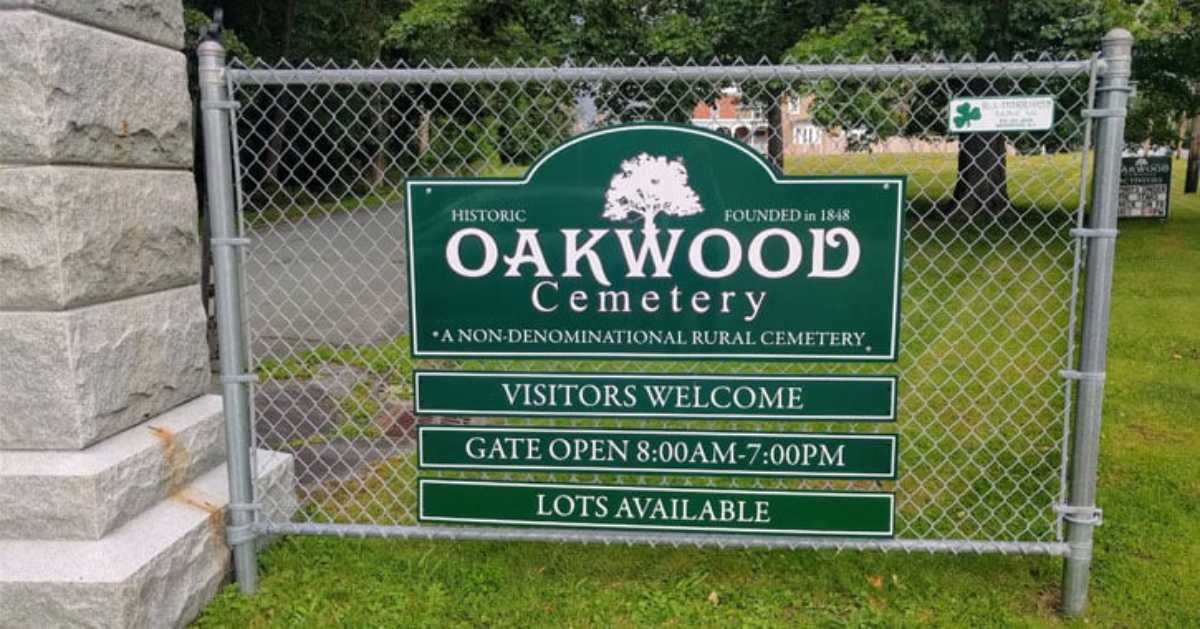 sign on a fence for Oakwood Cemetery