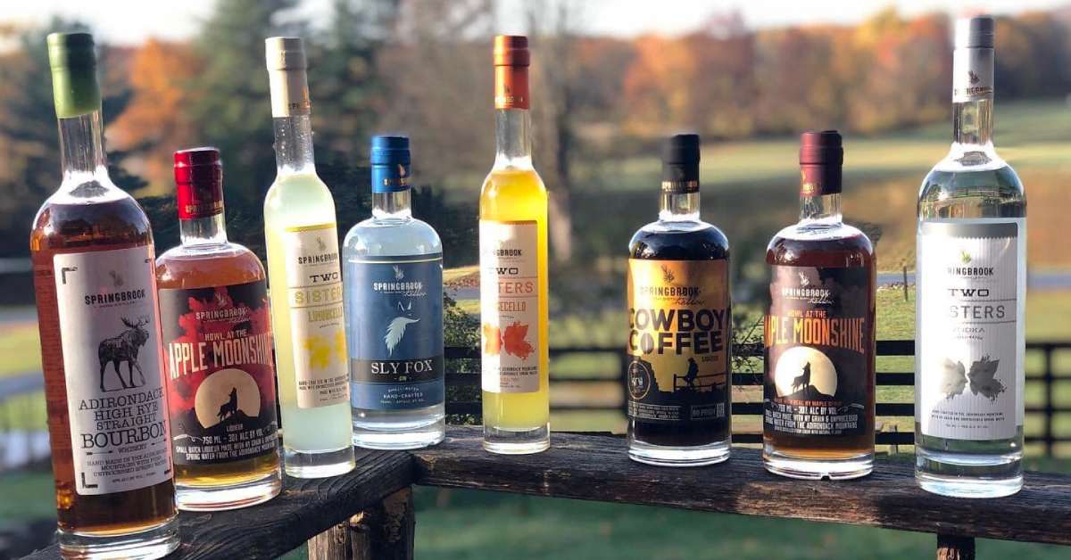 Springbrook Hollow distillery spirit bottles on a railing