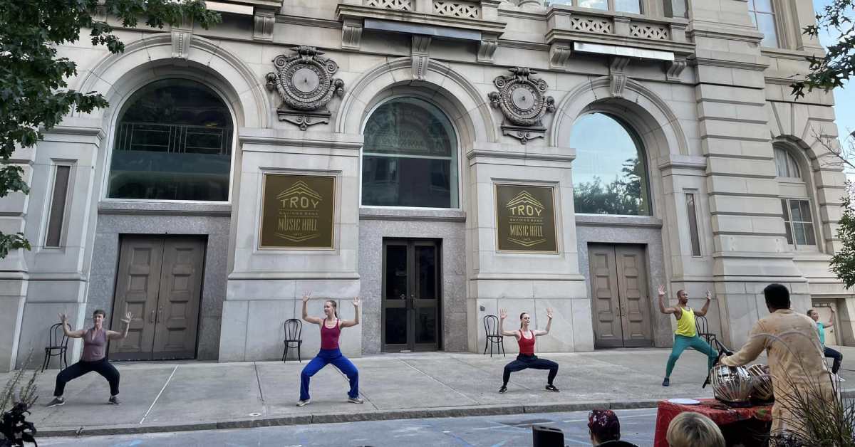 people doing dance moves outside a music hall