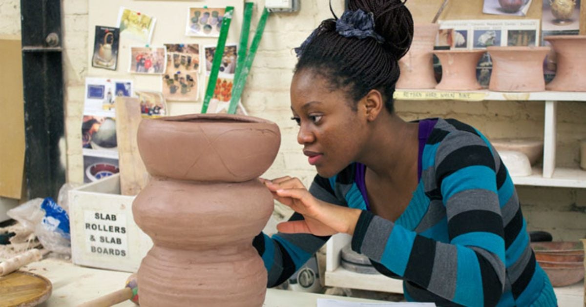 a woman working on pottery