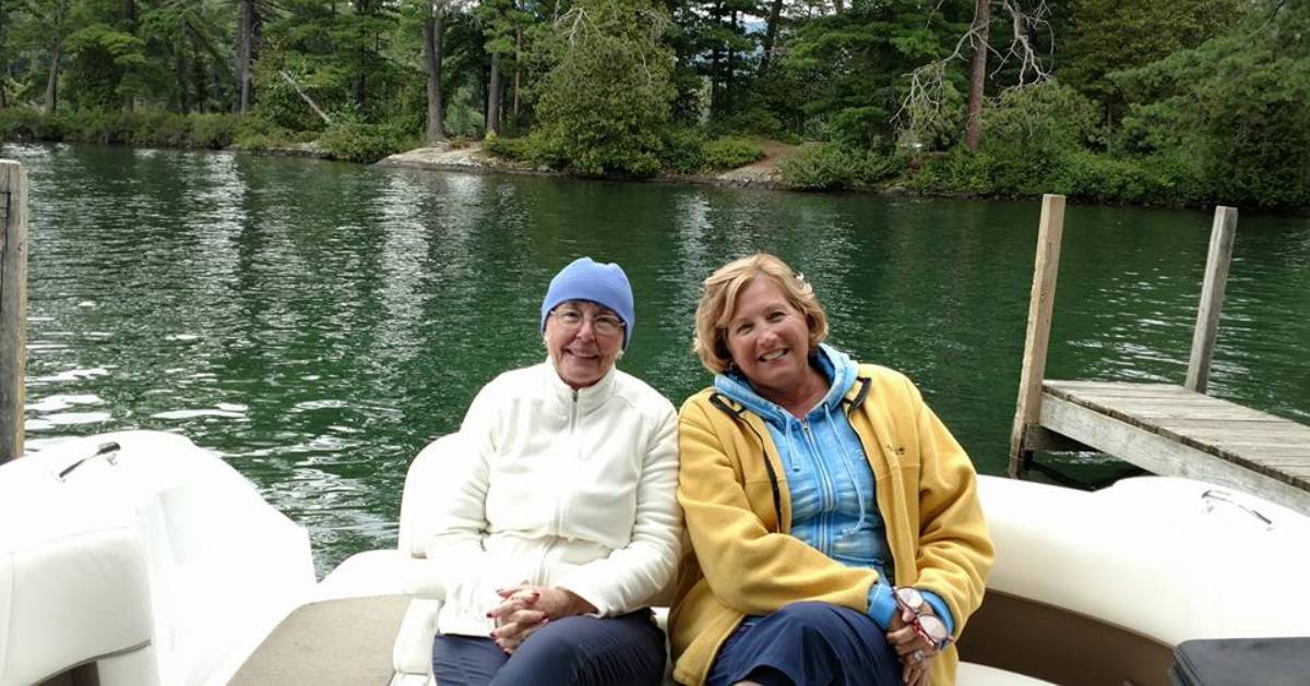 two women, maybe mother and daughter, on a boat posing