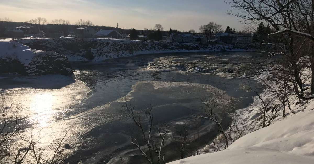 view of the river in winter with snow and ice 