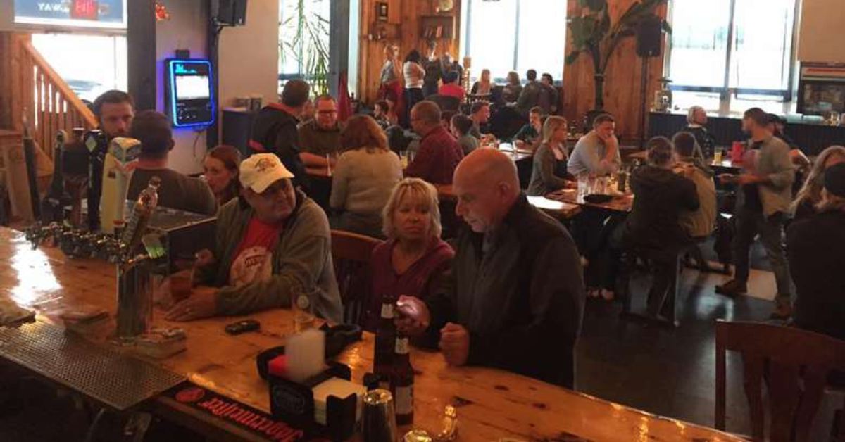 people seated at a bar talking