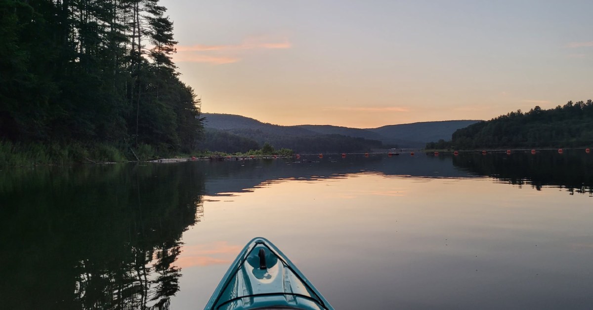 photo of kayaker on lake 