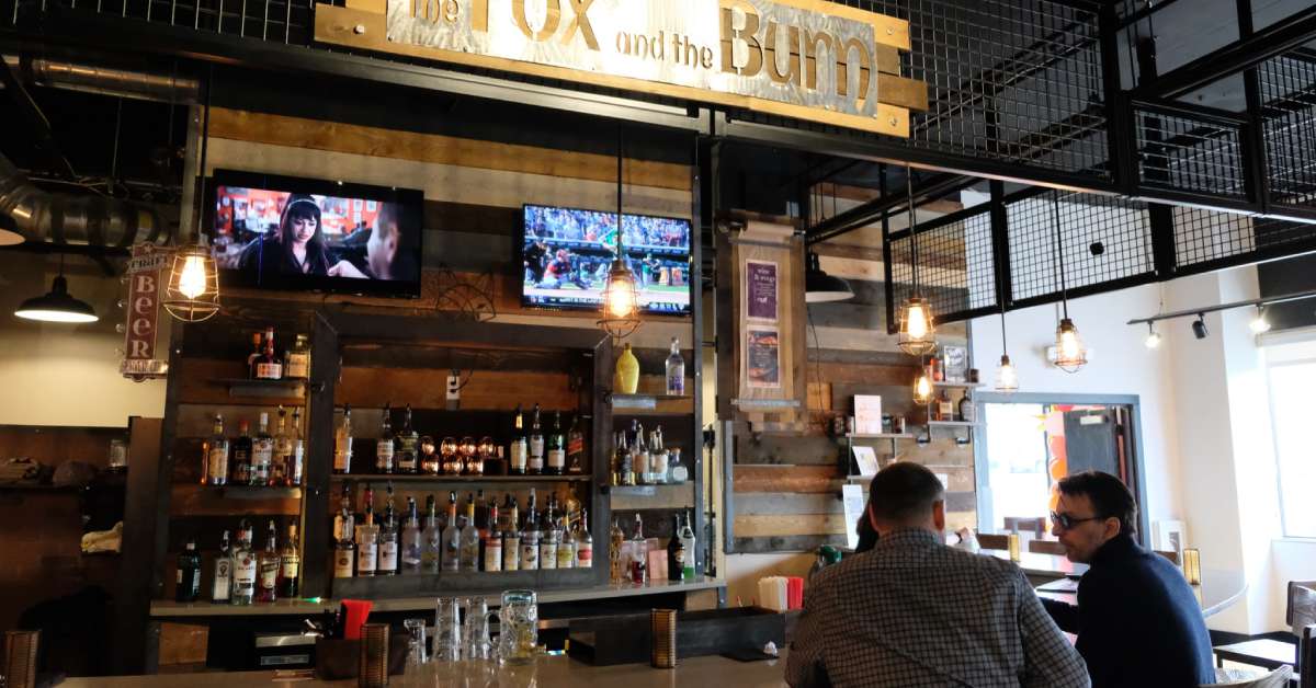 two men chatting at a bar