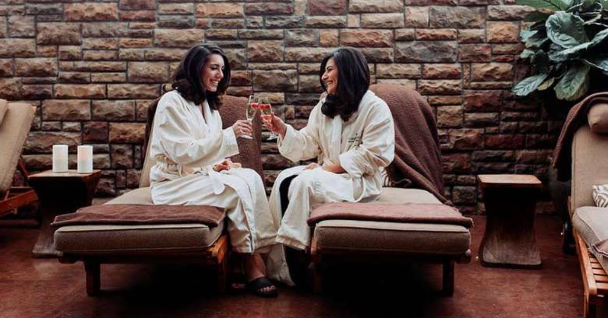 two women in robes toasting