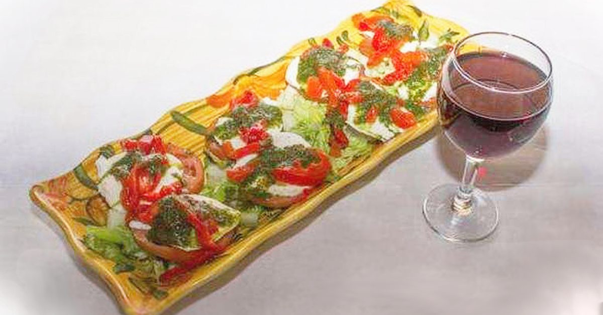 salad and glass of wine on a white background