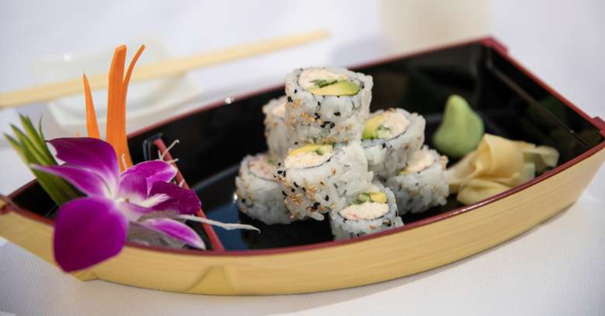 sushi on a boat with flower decoration