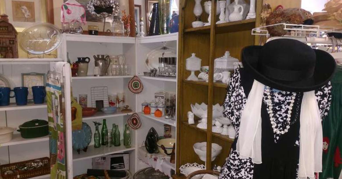 antique bottles and clothes in a store corner on shelves