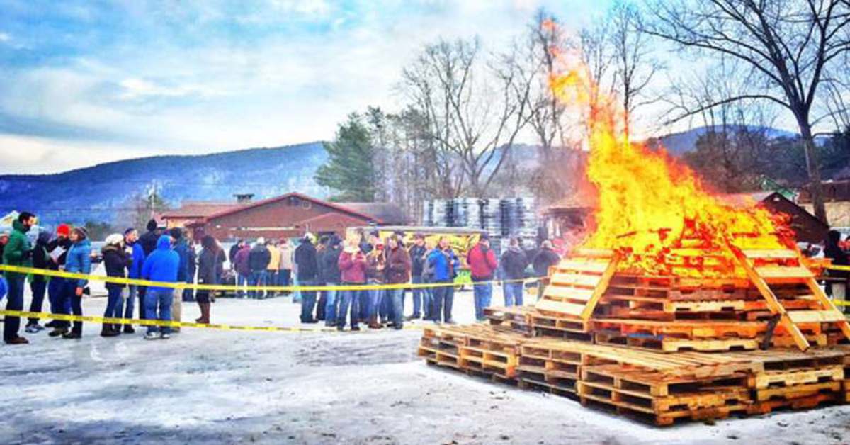 people next to a giant bonfire in winter