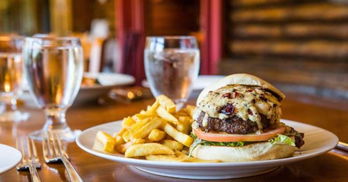 a burger with fries and water  