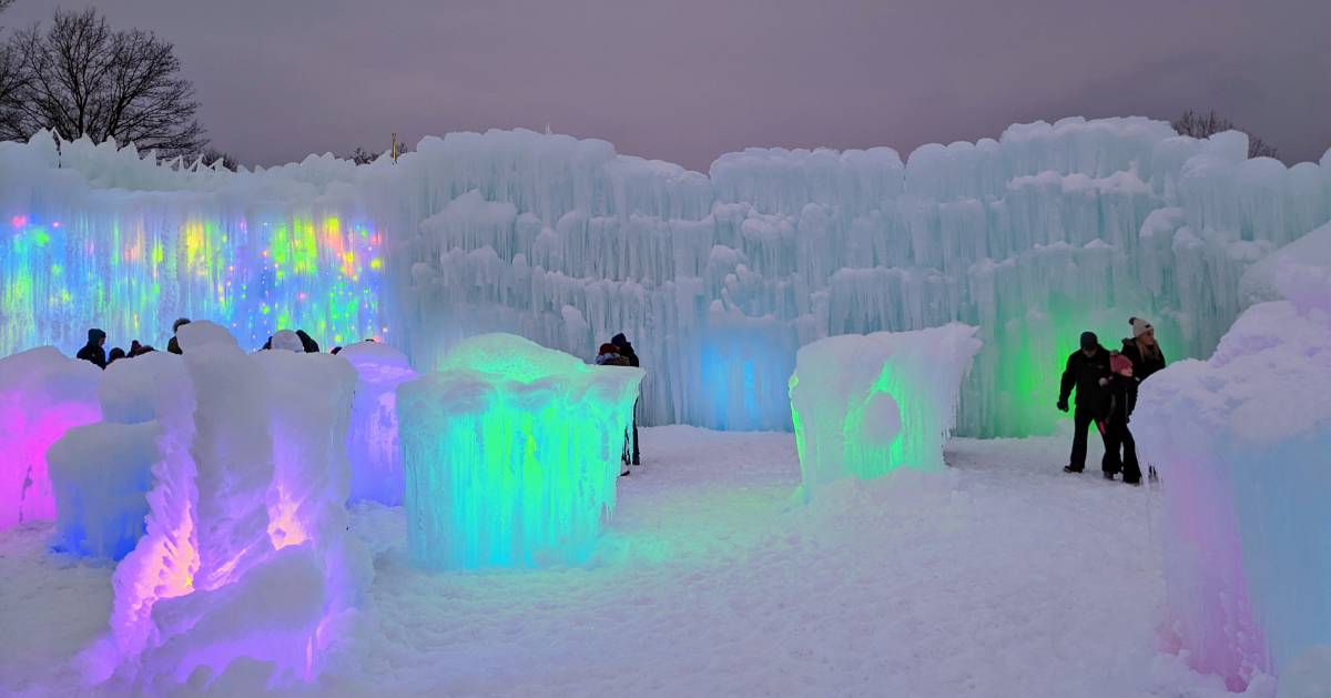 people walking around illuminated ice castles