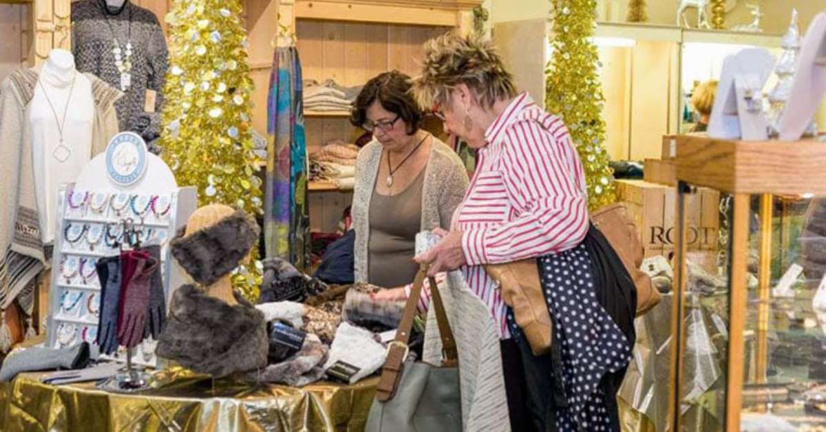 two women browsing clothes in a store