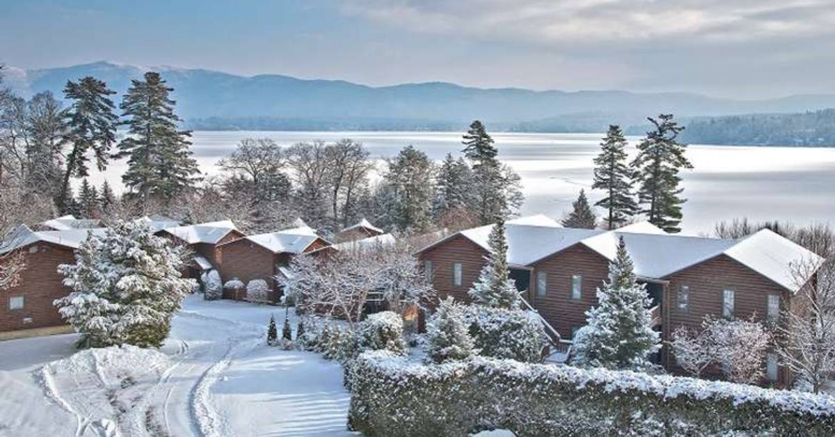 townhouses by a lake covered in snow