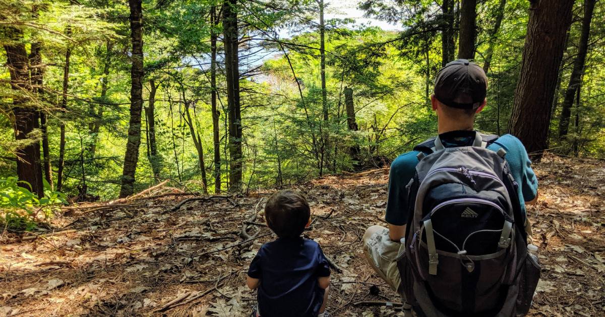 dad and kid on trail looking at something