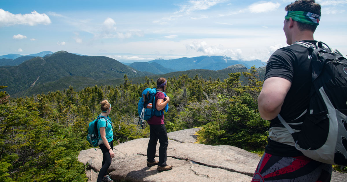 three hikers on a summit