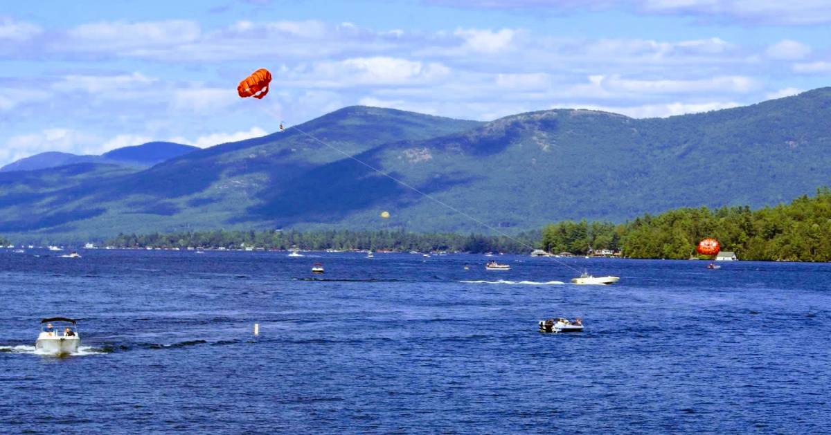 boat towing a parasail on lake george