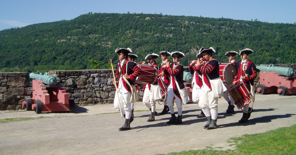 soldiers in red period attire marching