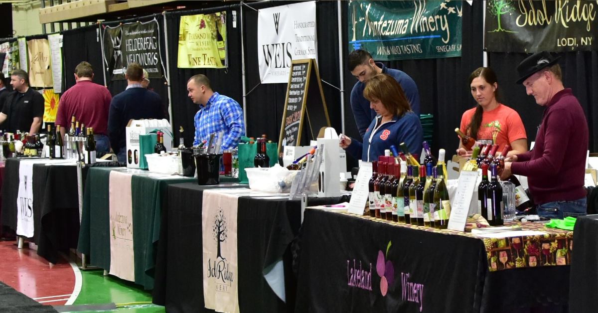 people at vendor tables for craft beverages