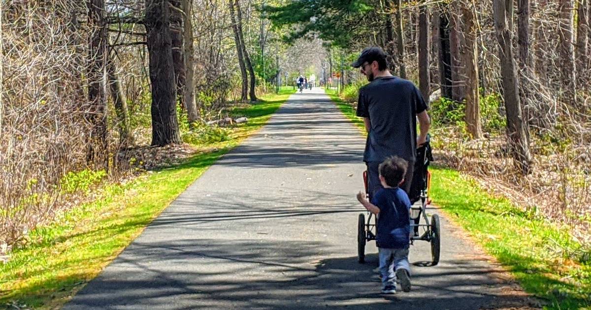 dad and child on bike path