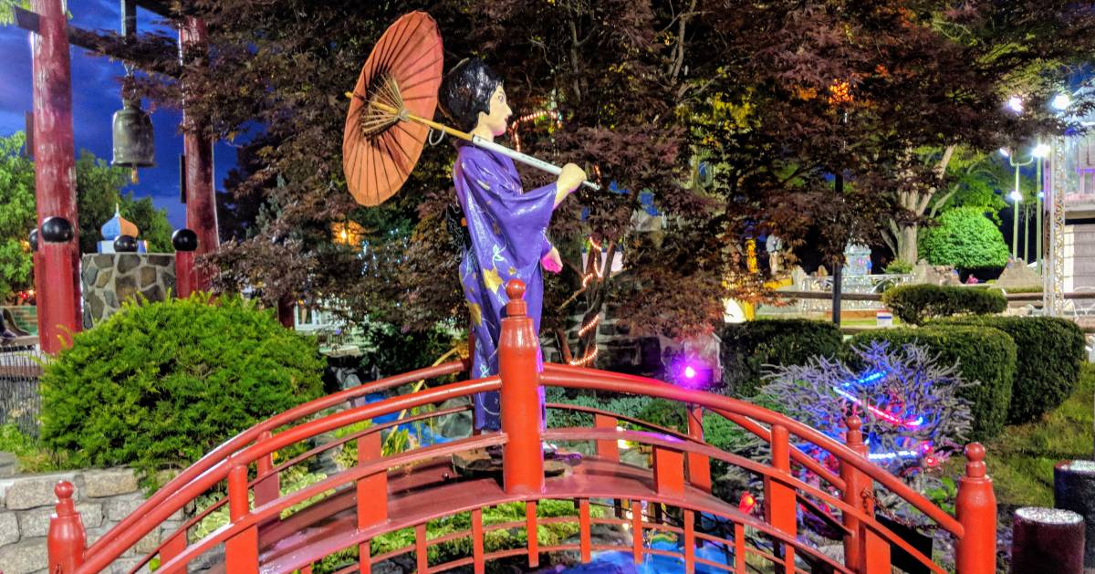 statue of Japanese woman walking over bridge at golf course