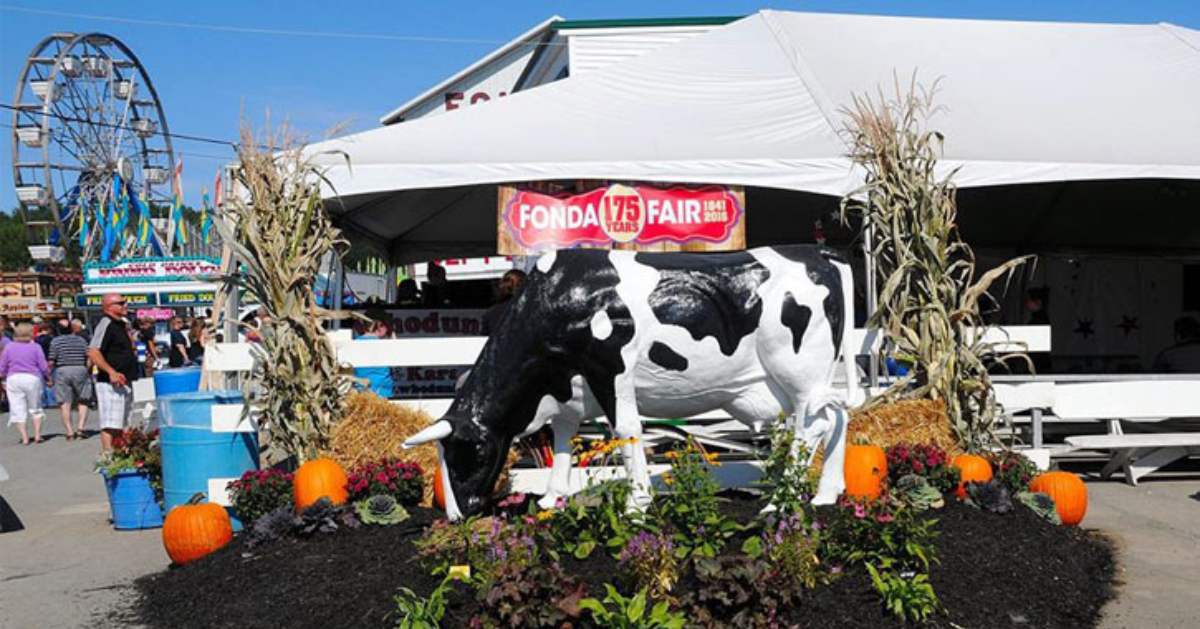 cow statue near a fair tent