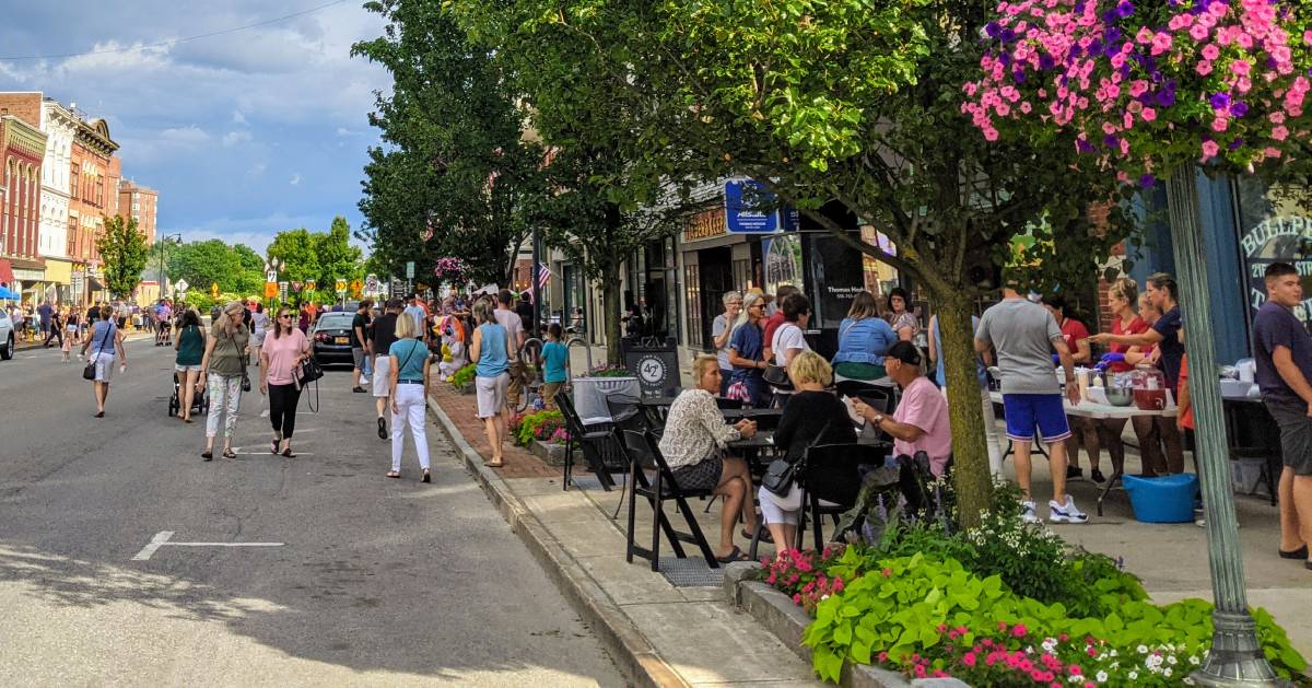 crowd on sidewalk and in street