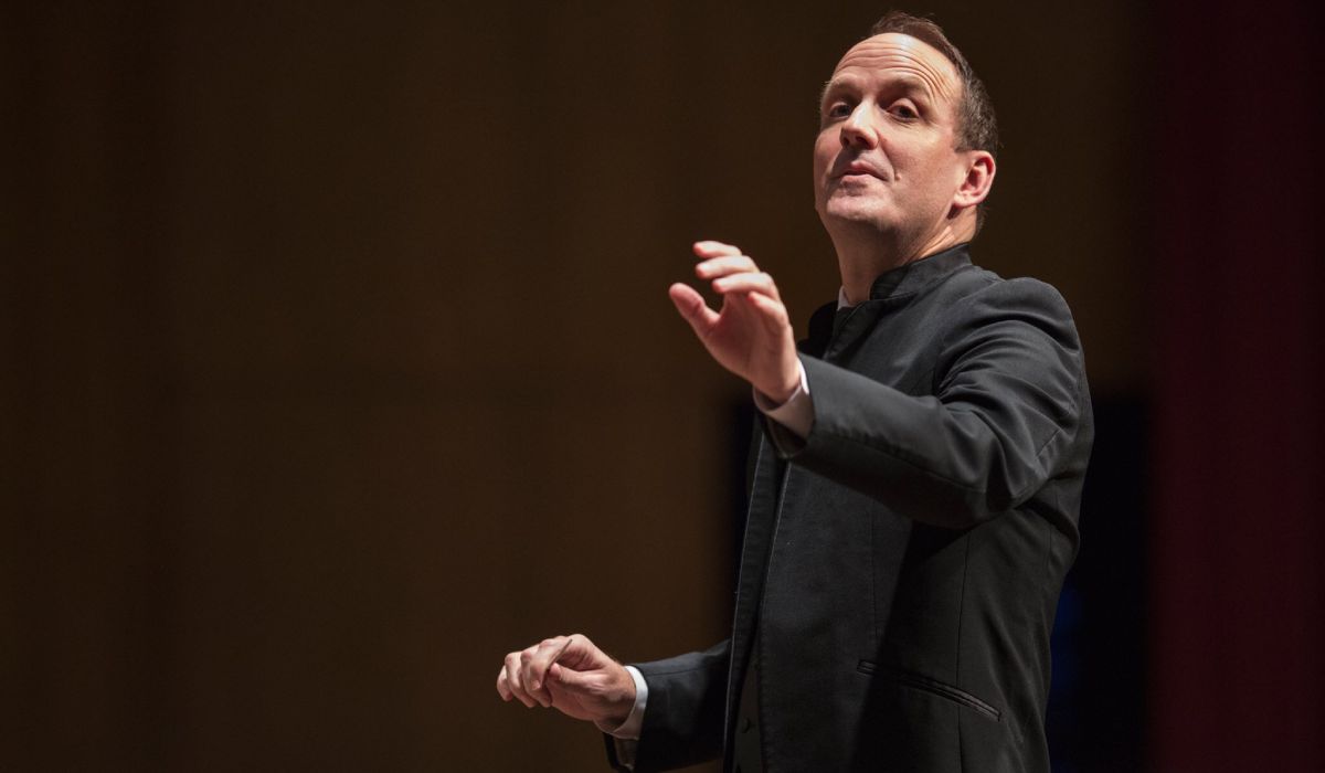 a male conductor on stage