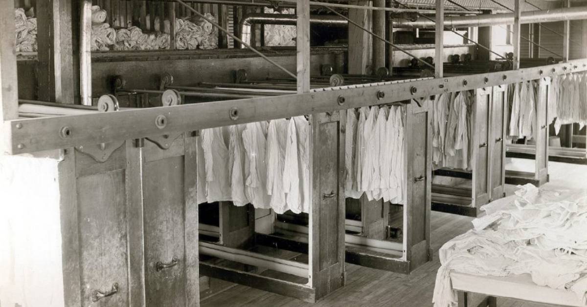 black and white photo of shirts in a factory