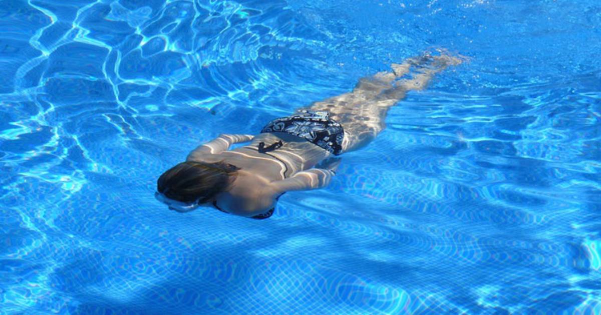 woman swimming underwater in a pool