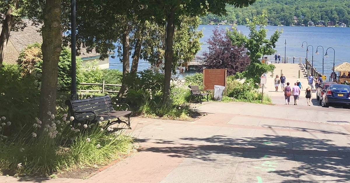 bench near water, people walking