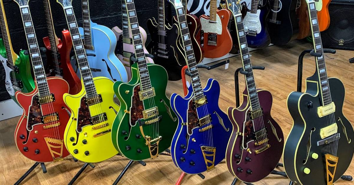 a lineup of colorful guitars