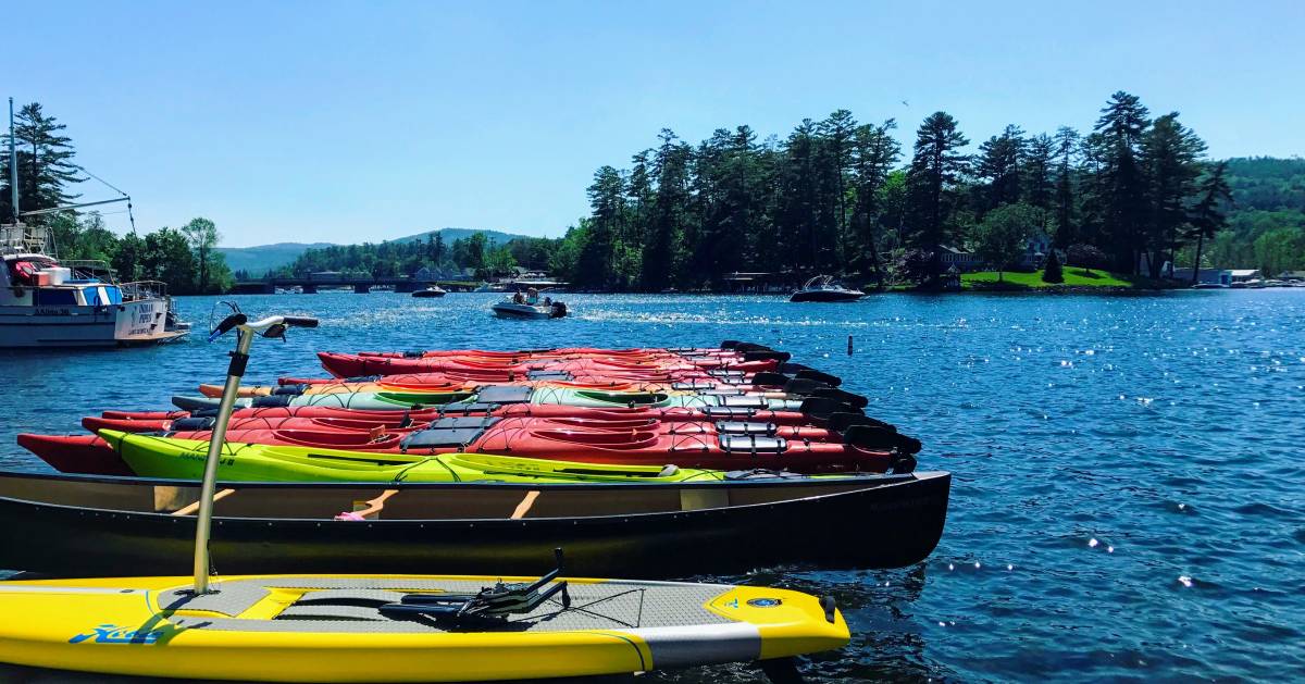 colorful kayaks in the water lined up