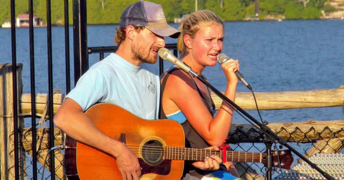 a couple singing with guitar and microphones