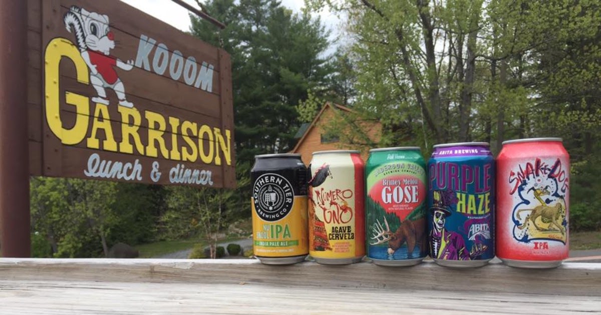 beer cans lined up by Garrison sign