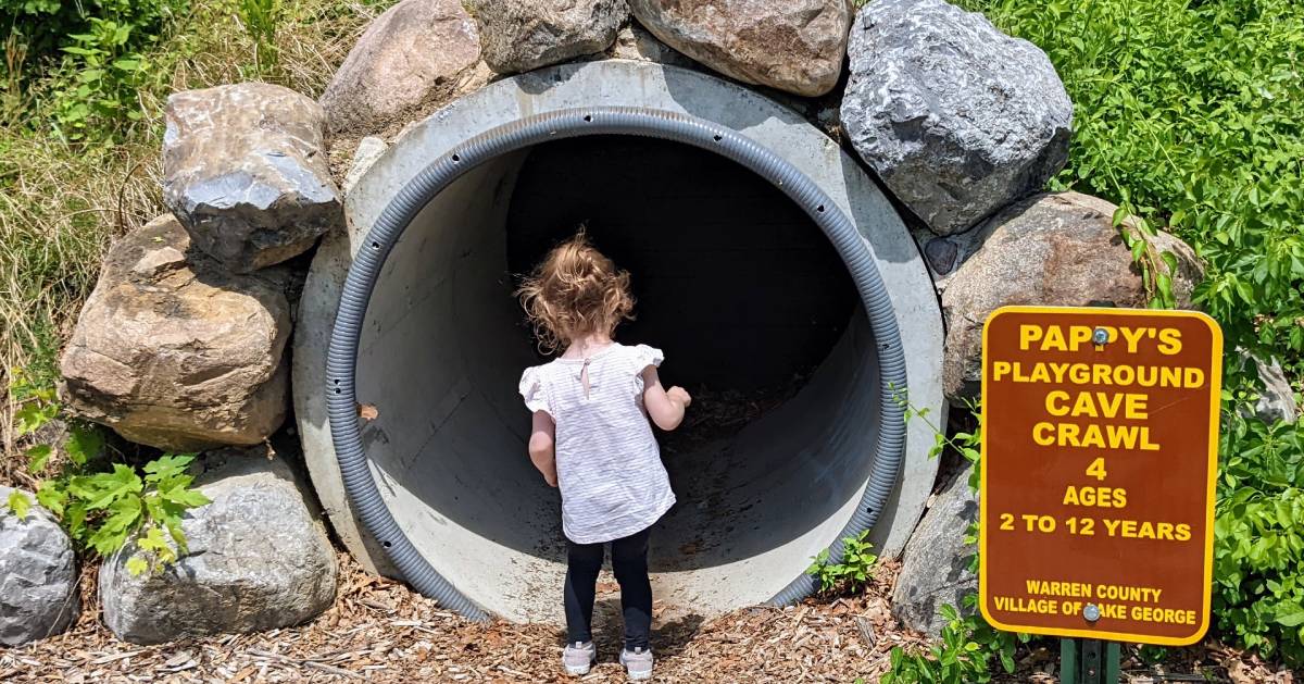 little girl at playground cave