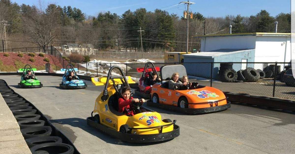 people in go karts outdoors