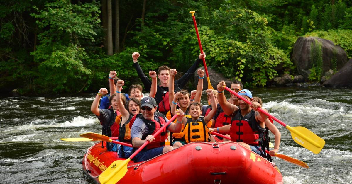 happy group of people rafting, kid in the center