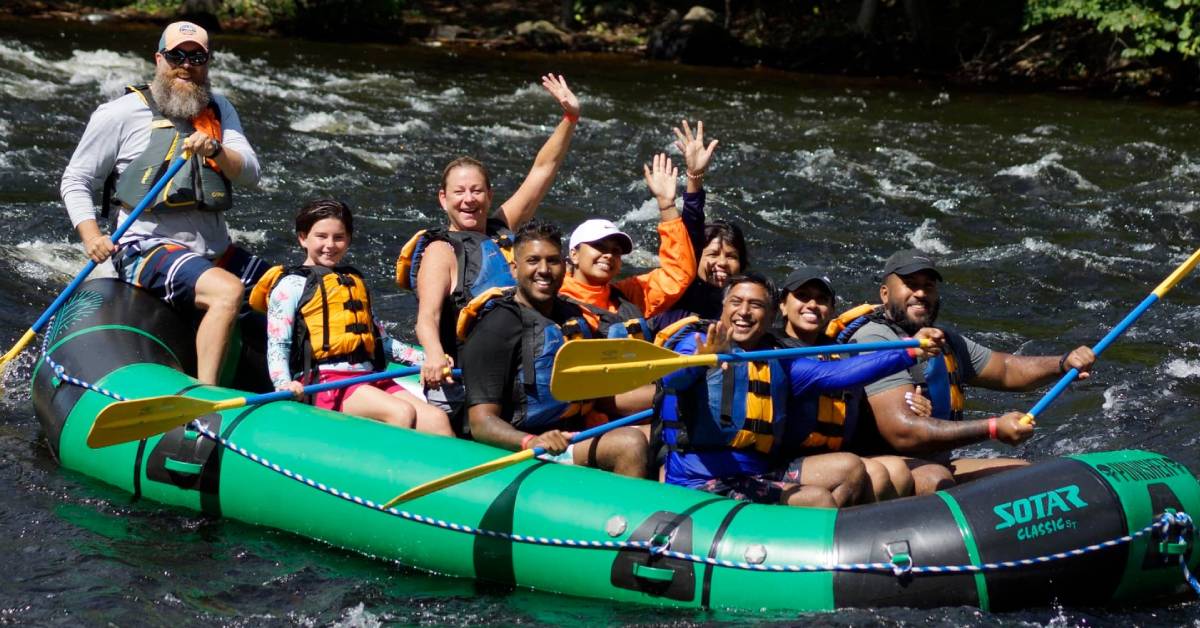 group of happy people rafting