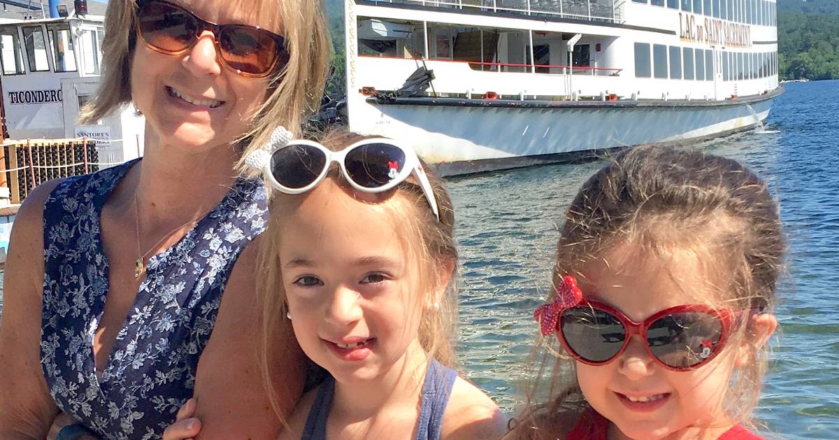  mom poses with daughters in front of steamboat