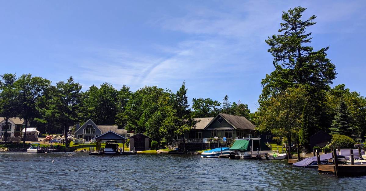 view from lake of houses with boats docked