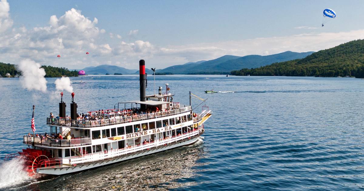 cruise ship and parasailers on a lake