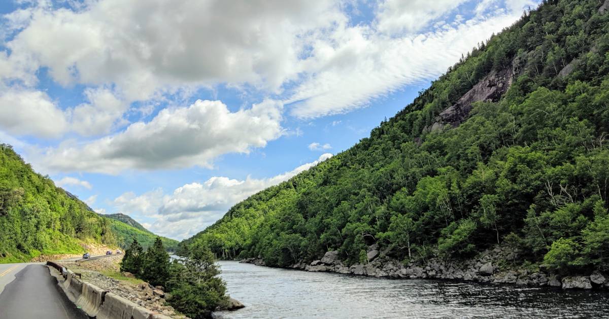 road in the Adirondacks going by river and mountain