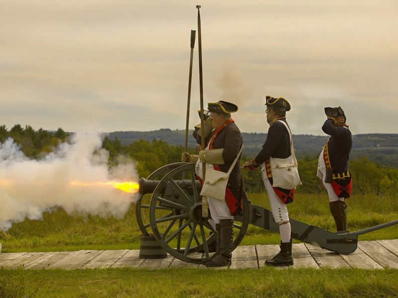 Revolutionary War Reenactors firing a cannon at Saratoga Battlefield