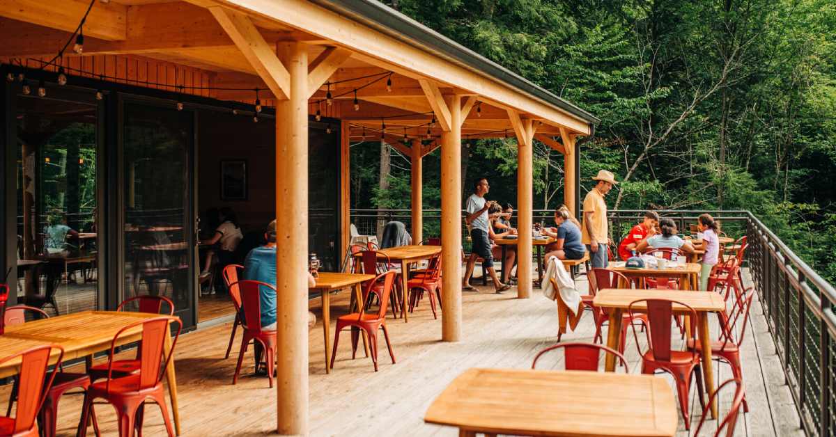 large outdoor deck seating area with tables and chairs