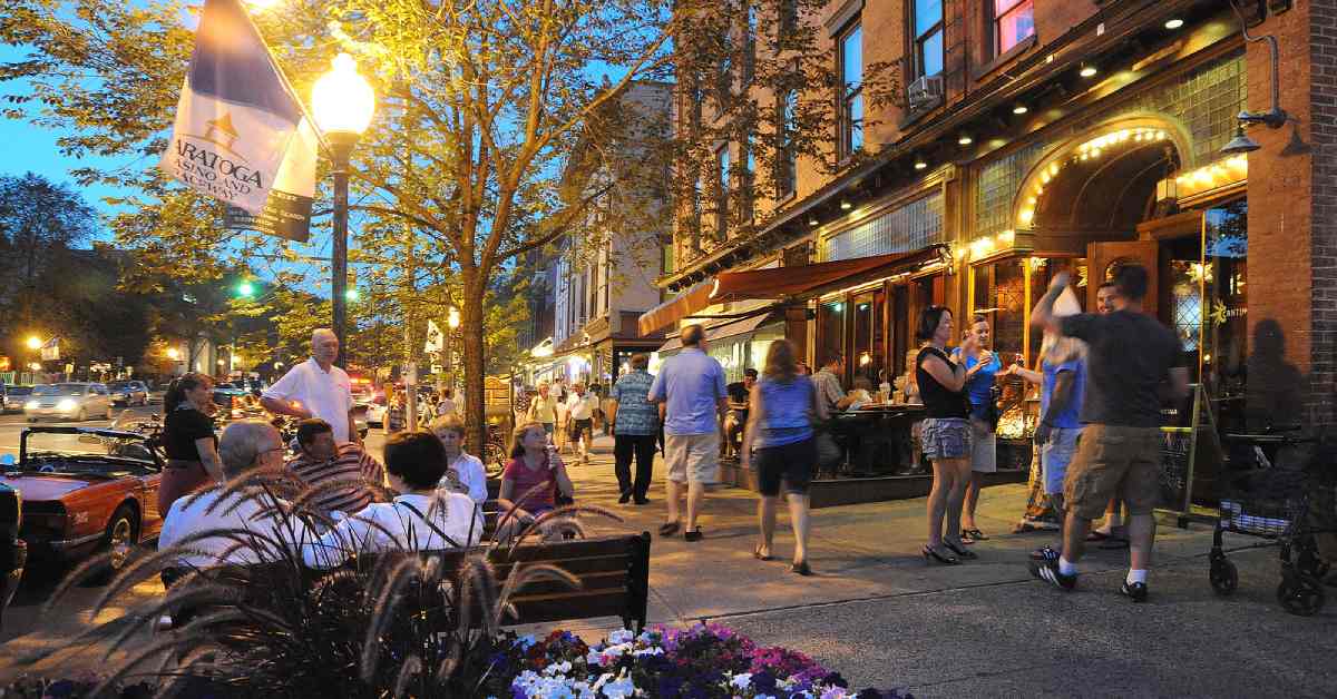 people strolling along downtown saratoga in the evening