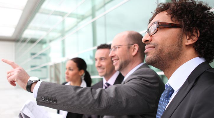 coworkers on a business trip, one of them is pointing at something