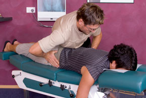 chiropractor adjusts womans spine
