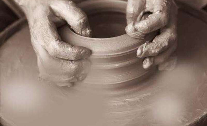 hands making pottery